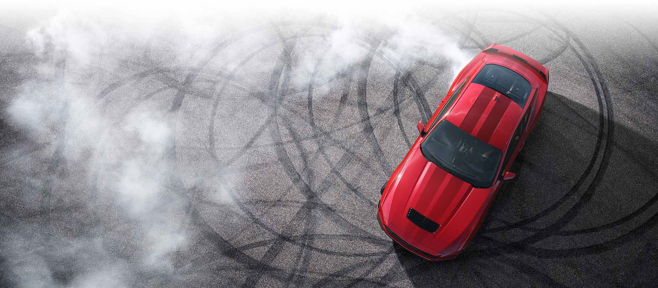 Overhead view of a 2024 Ford Mustang® model with tire tracks on pavement | Ed Morse Ford in Muscatine IA
