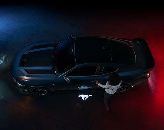 2024 Ford Mustang® Dark Horse™ model with a driver approaching the vehicle | Ed Morse Ford in Muscatine IA